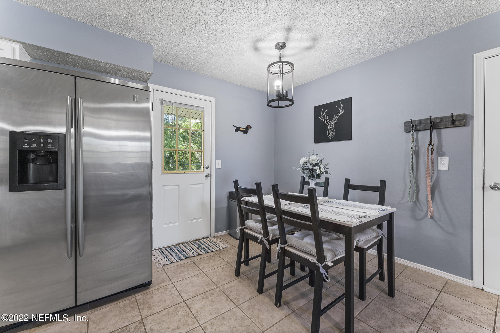 648 West Oliver Street Baldwin, FL 32234 - Photo 10 of 30 a view of a dining room with furniture window and wooden floor