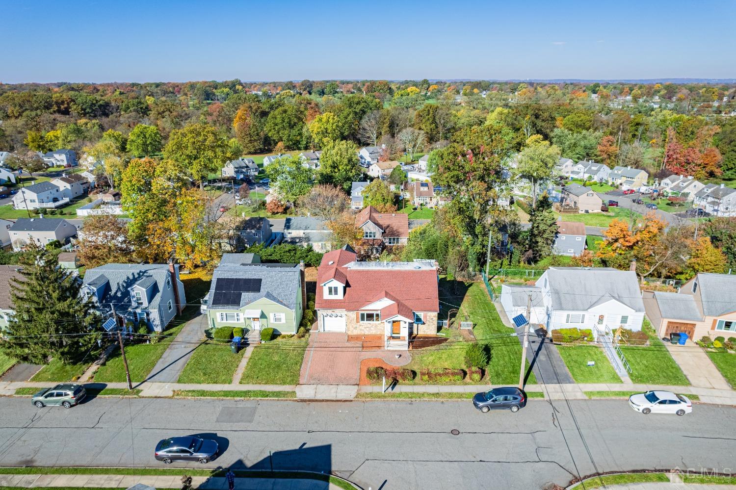 an aerial view of residential houses with outdoor space and parking
