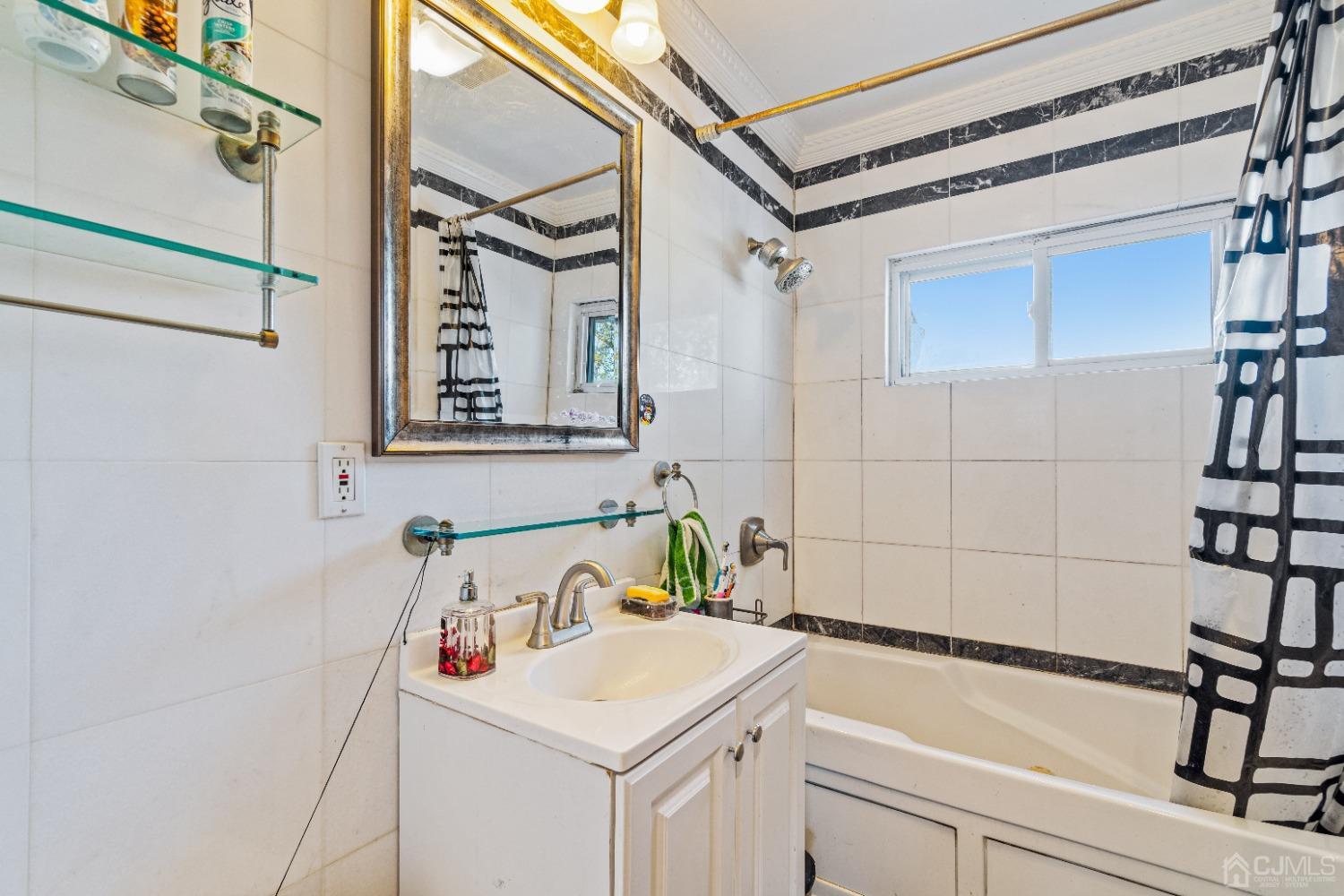 185 Midfield Road Colonia, NJ 07067 - Photo 13 of 27 a bathroom with a sink and a bathtub