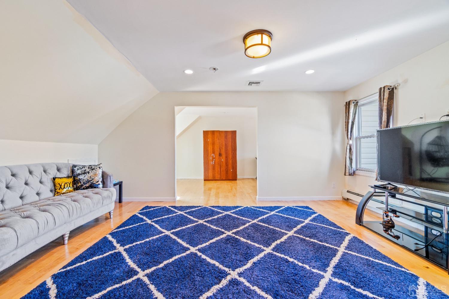 185 Midfield Road Colonia, NJ 07067 - Photo 14 of 27 a bedroom with a bed and a flat tv screen on dresser