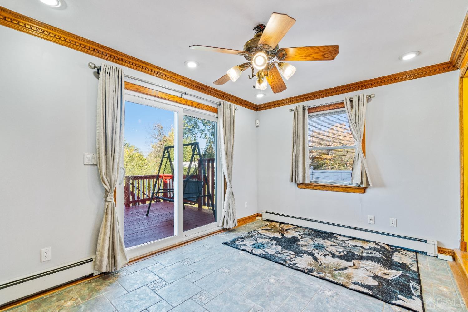 185 Midfield Road Colonia, NJ 07067 - Photo 21 of 27 a view of a hallway with a dining table and a chandelier