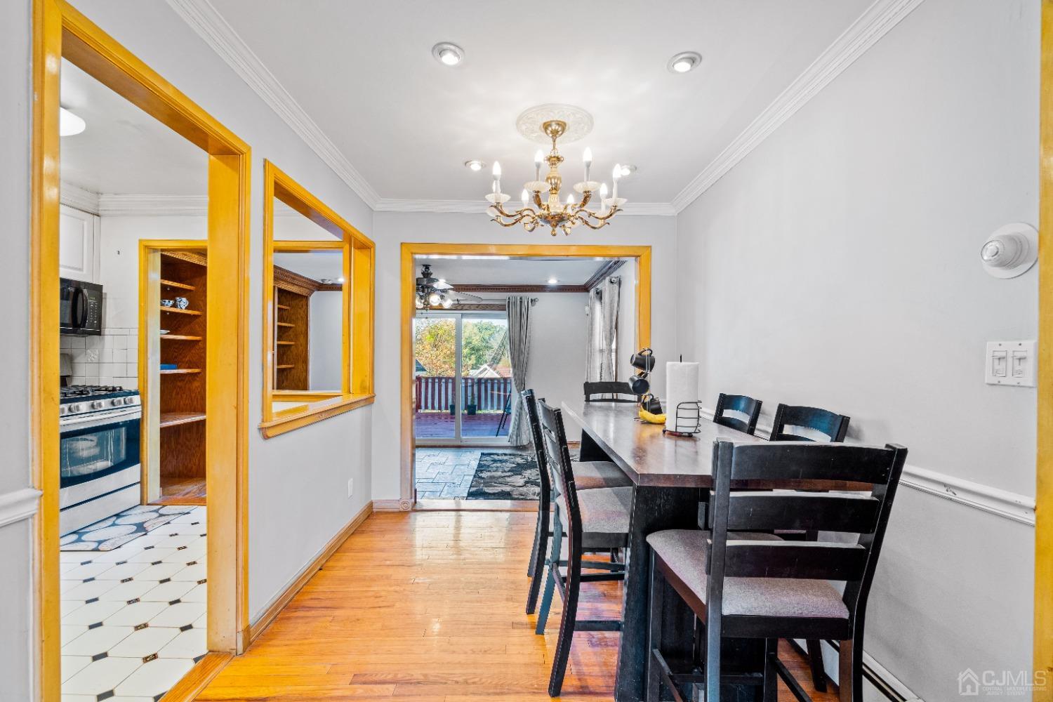 185 Midfield Road Colonia, NJ 07067 - Photo 6 of 27 a dining room with furniture and chandelier