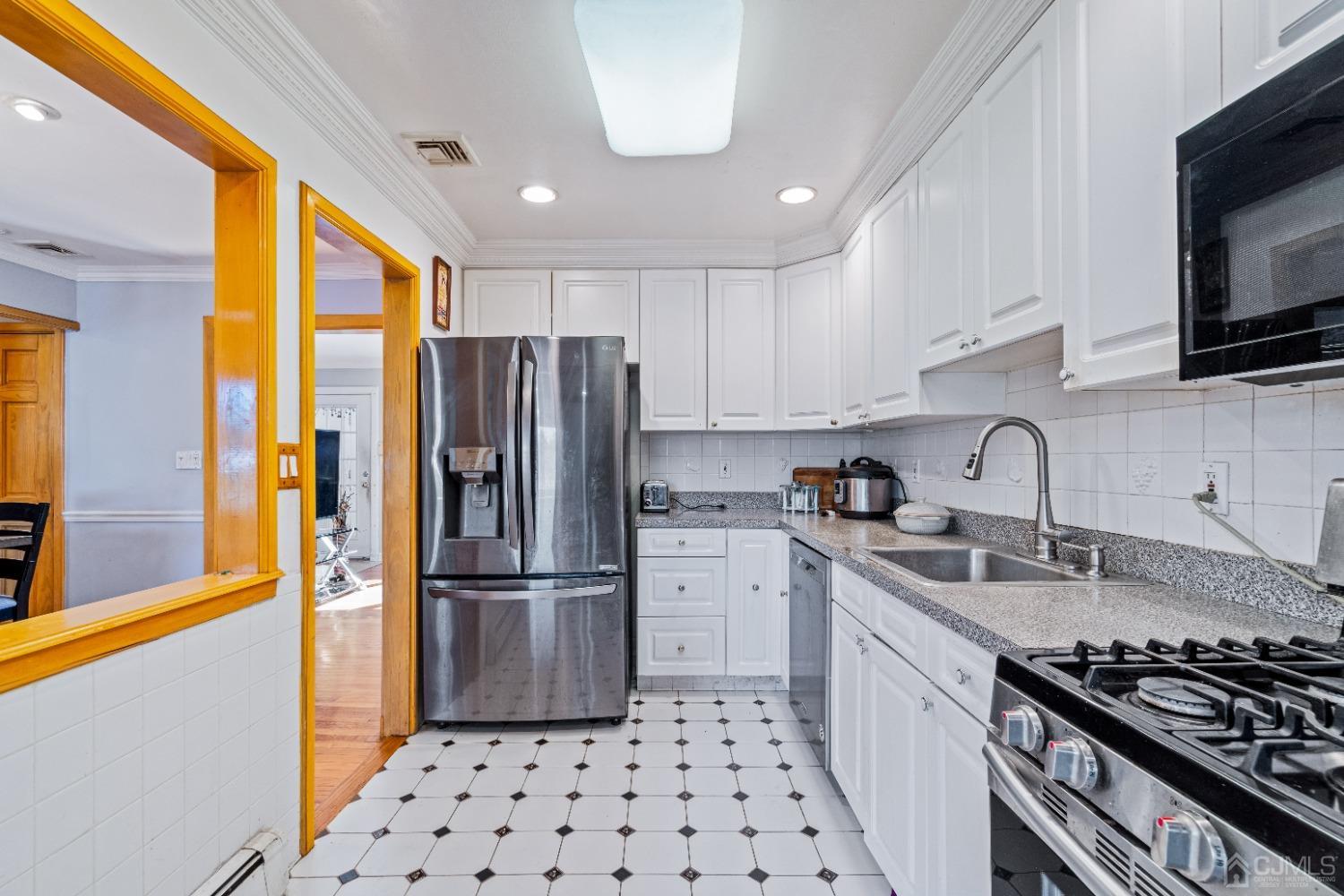 185 Midfield Road Colonia, NJ 07067 - Photo 9 of 27 a kitchen with stainless steel appliances granite countertop a refrigerator and a sink
