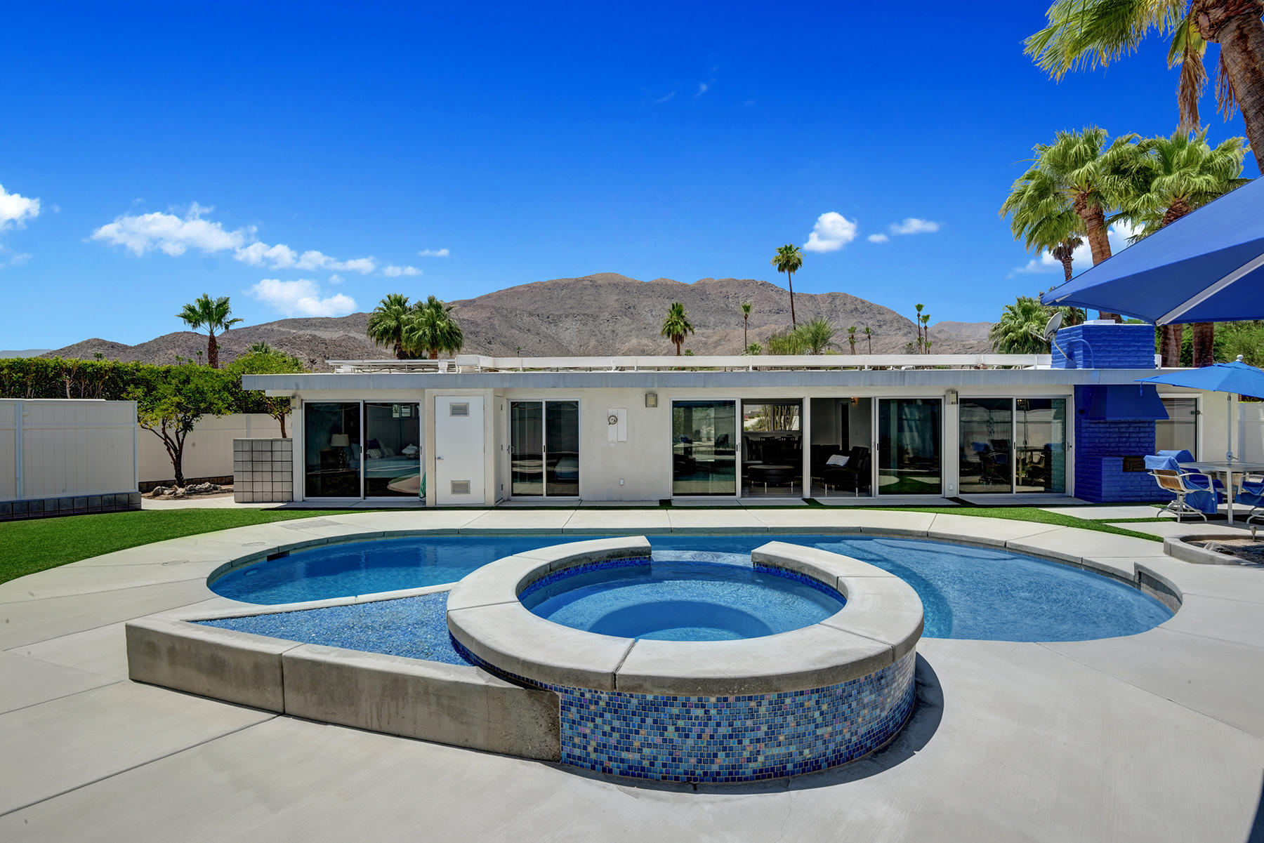 71704 Tunis Road Rancho Mirage, CA 92270 - Photo 2 of 47 a view of a house with swimming pool and a yard