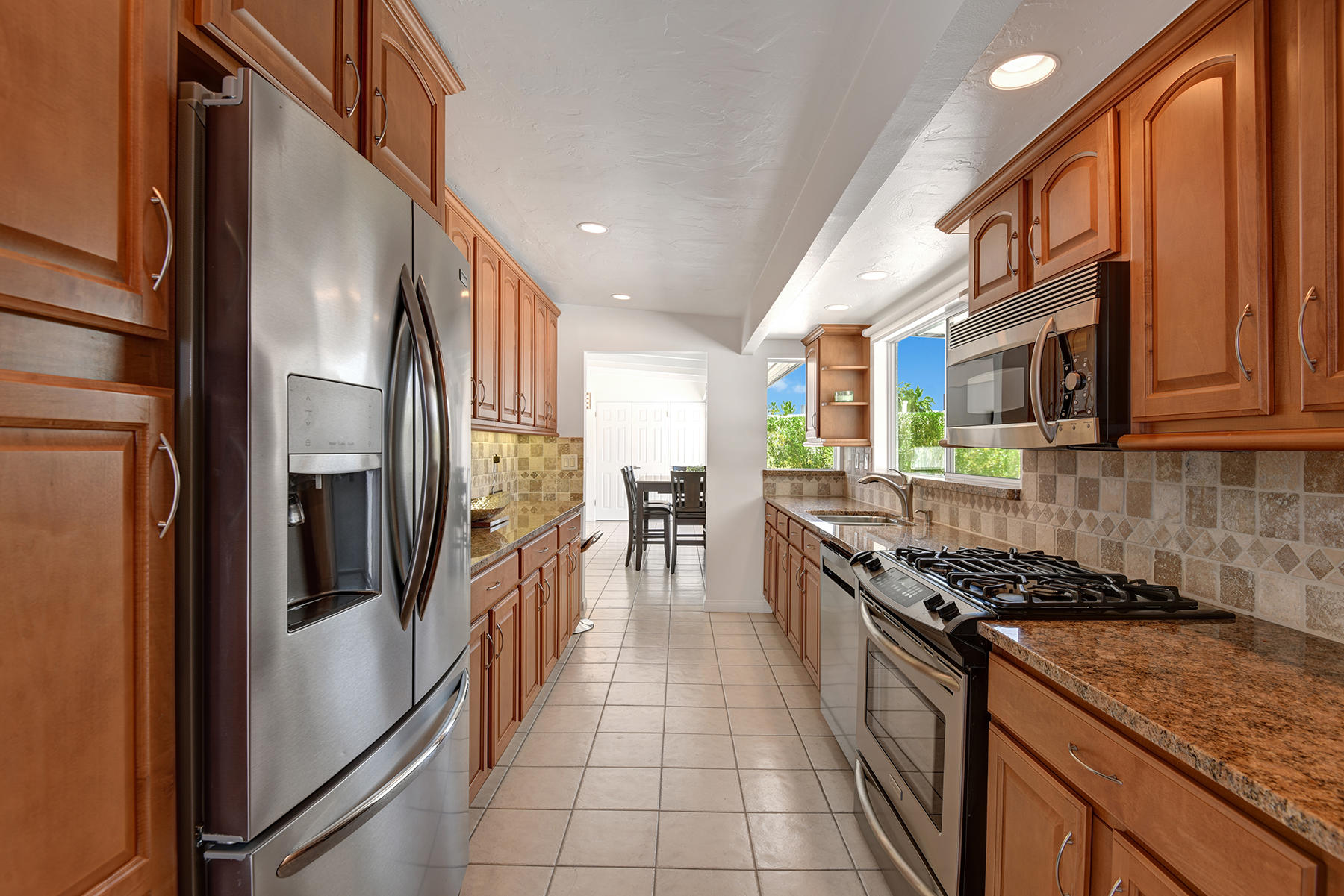 71704 Tunis Road Rancho Mirage, CA 92270 - Photo 14 of 47 a kitchen with stainless steel appliances granite countertop a refrigerator a stove and a sink