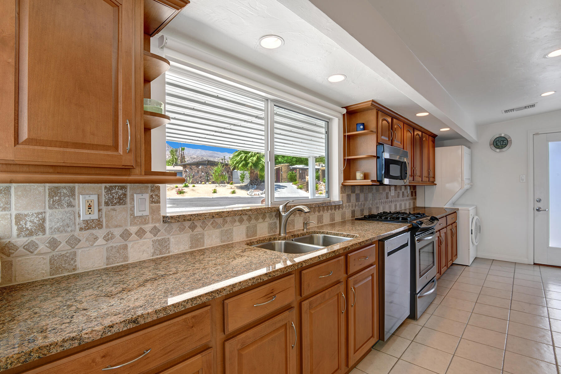 71704 Tunis Road Rancho Mirage, CA 92270 - Photo 15 of 47 a kitchen with stainless steel appliances granite countertop a sink and a stove