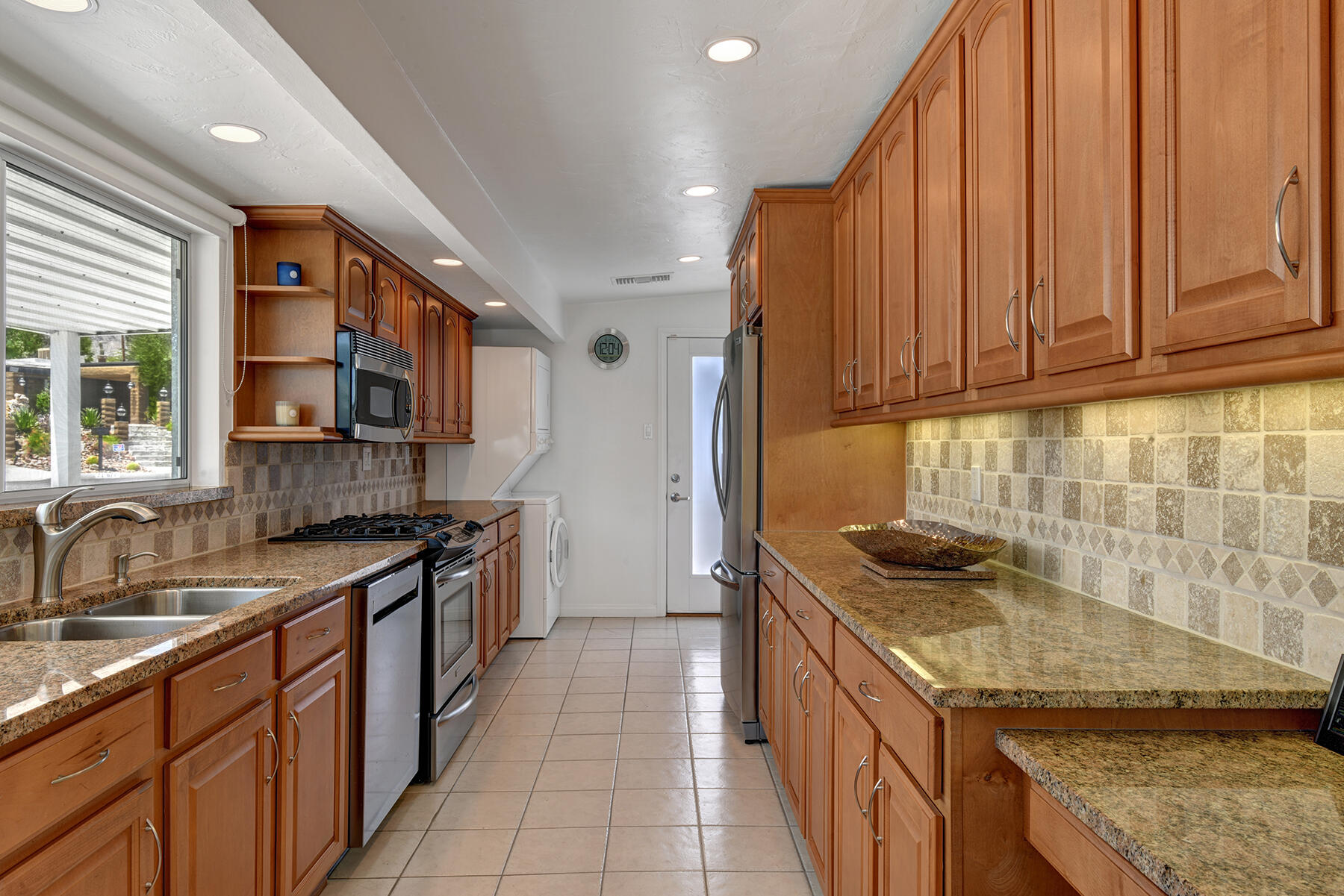 71704 Tunis Road Rancho Mirage, CA 92270 - Photo 16 of 47 a kitchen with stainless steel appliances granite countertop a sink stove and cabinets