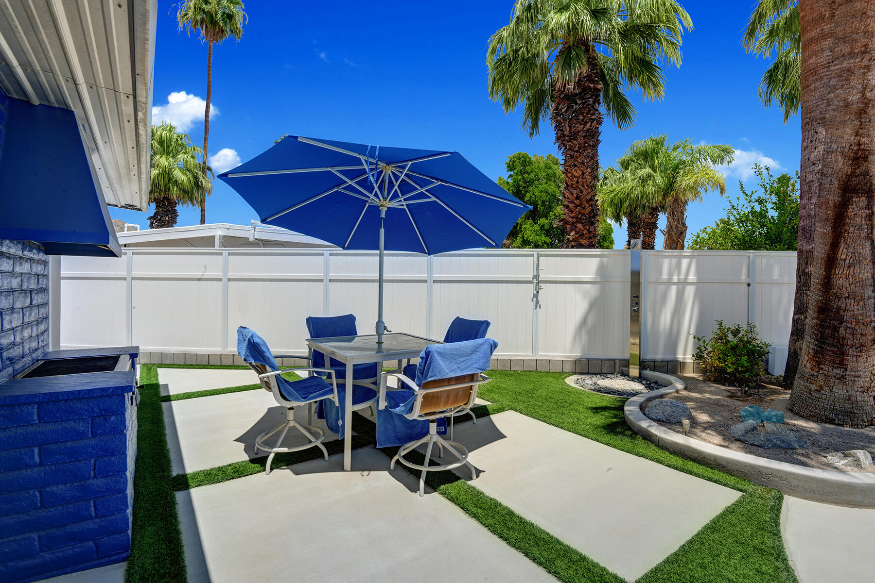 71704 Tunis Road Rancho Mirage, CA 92270 - Photo 33 of 47 a view of a patio with table and chairs under an umbrella