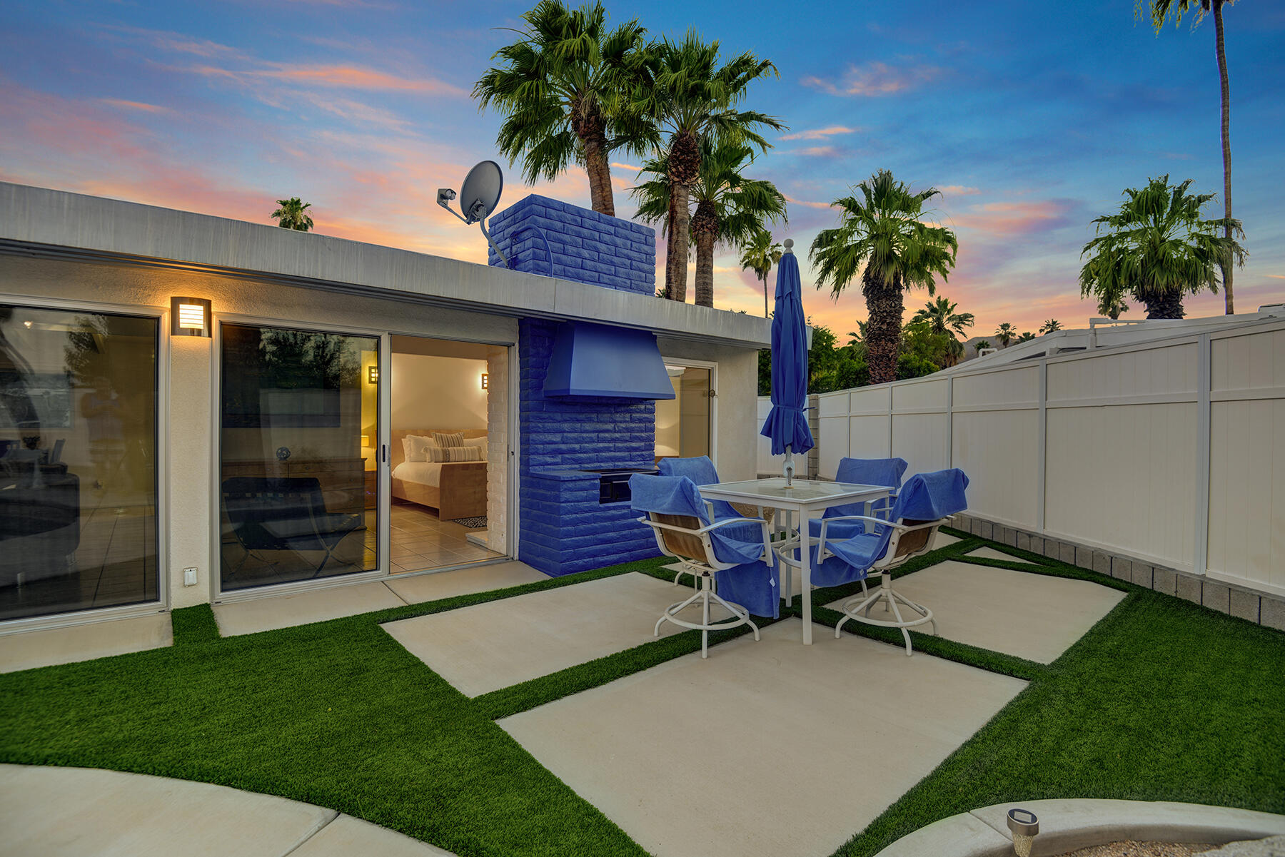 71704 Tunis Road Rancho Mirage, CA 92270 - Photo 42 of 47 a view of a patio with table and chairs potted plants and palm tree
