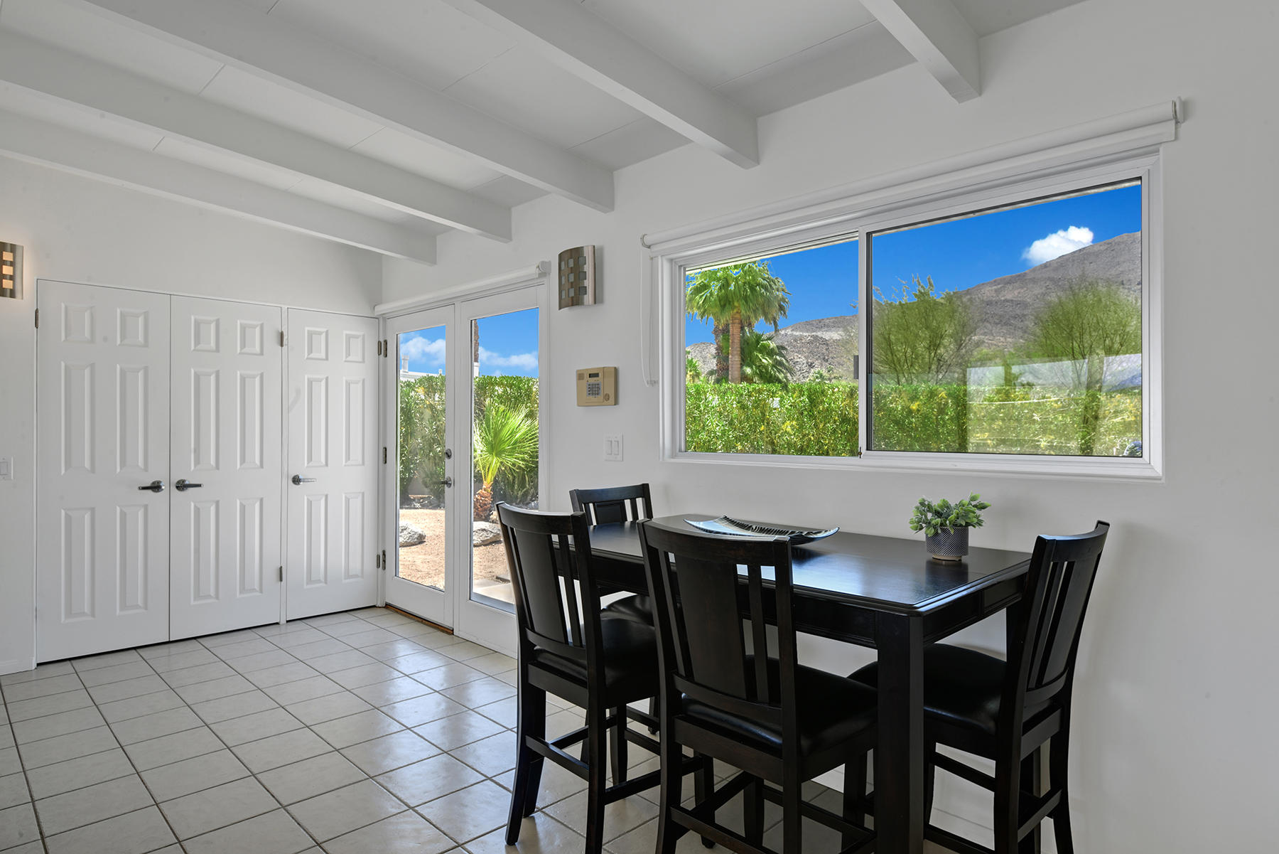71704 Tunis Road Rancho Mirage, CA 92270 - Photo 6 of 47 a view of a dining room with furniture large windows and wooden floor