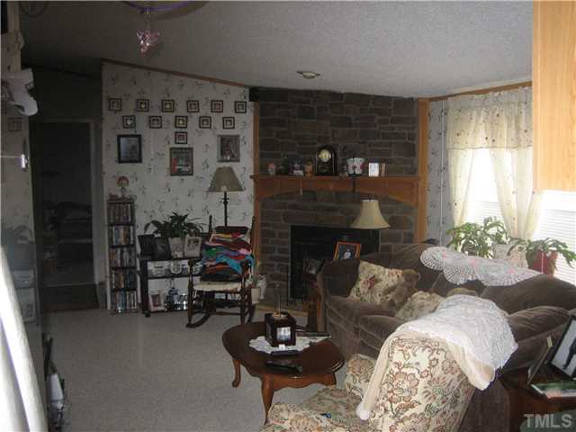 4710 Trinity Lane Rougemont, NC 27572 - Photo 4 of 6 Family room shown opens to living room and creates a large open area.