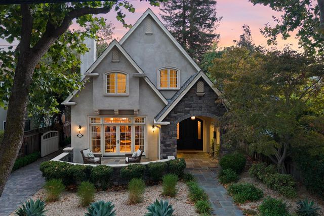 a view of a house with sitting area and garden