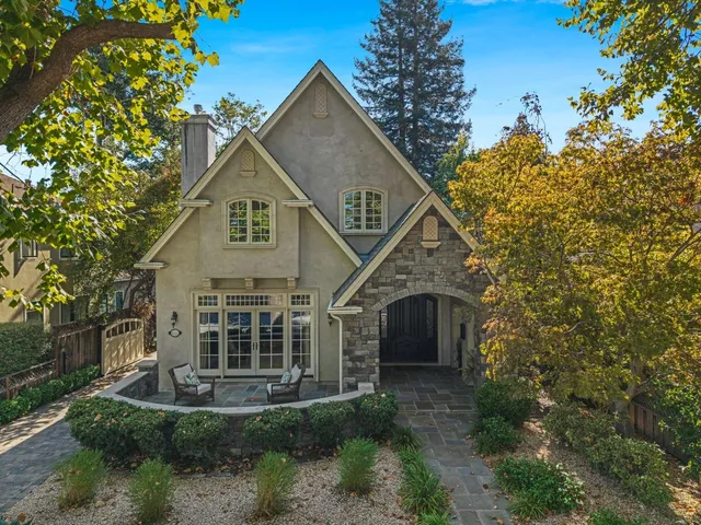 a front view of a house with a garden and plants
