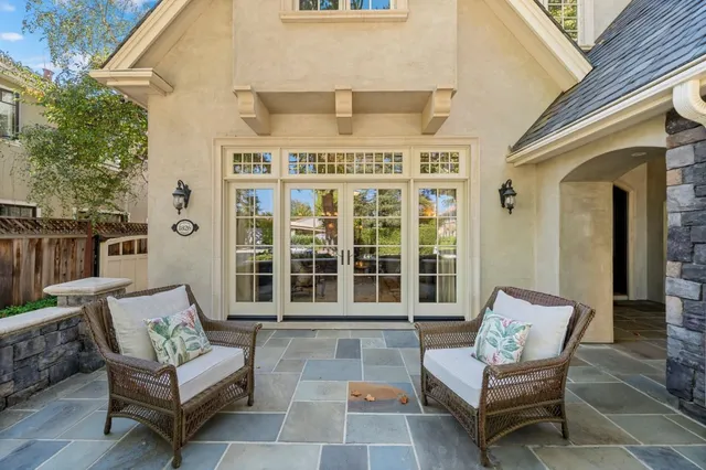 a view of a patio with a table and chairs