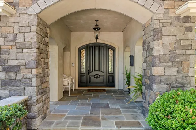 a front view of a building with a garden