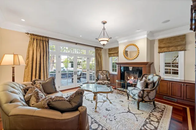 a living room with fireplace furniture and a large window