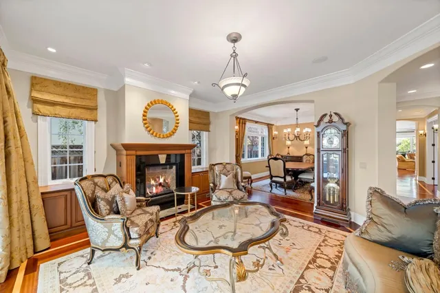 a living room with fireplace furniture and a large window