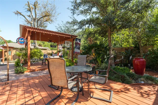 a view of backyard with wheel chair potted plants and wooden fence