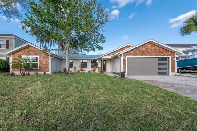 a front view of a house with a yard and garage