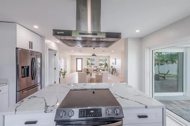 a kitchen with stainless steel appliances granite countertop a stove and a refrigerator