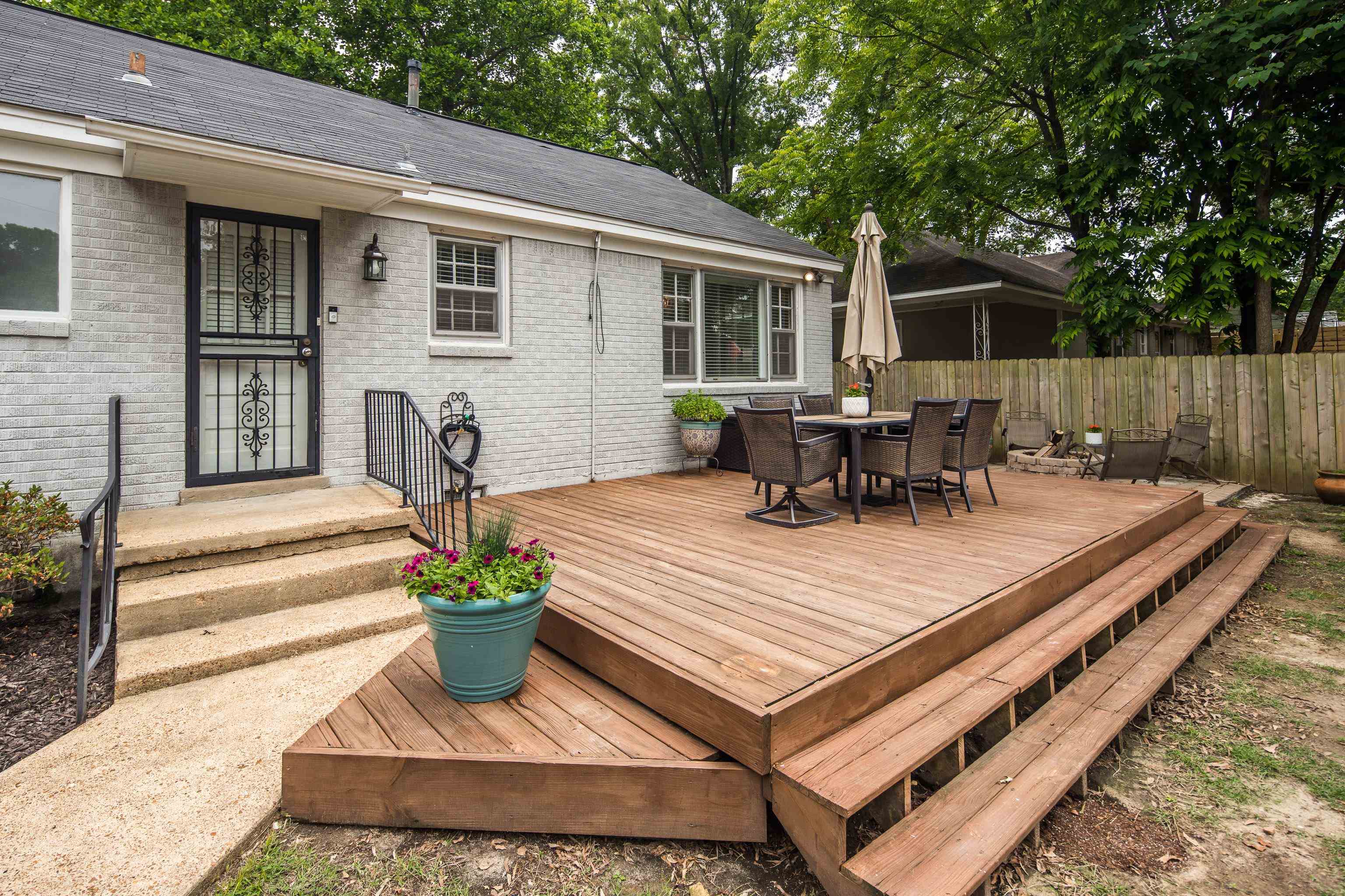 1157 Colonial Road Memphis, TN 38117 - Photo 17 of 25 a view of a patio with table and chairs potted plants and floor to ceiling window