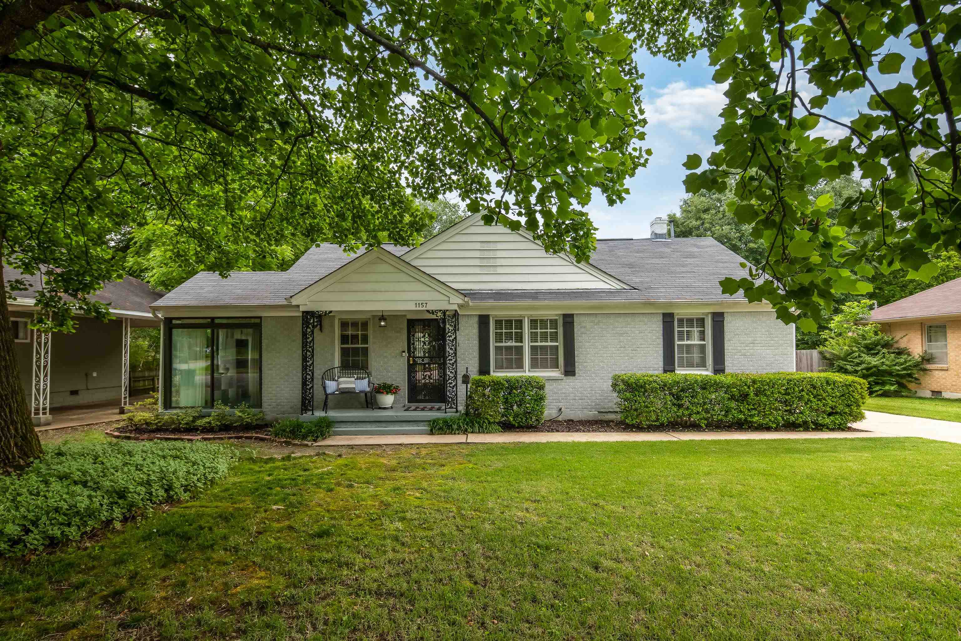 1157 Colonial Road Memphis, TN 38117 - Photo 2 of 25 a front view of a house with a yard