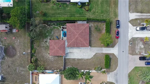 an aerial view of a house with a yard basket ball court and outdoor seating