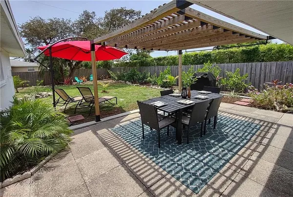 an outdoor space with furniture and umbrella