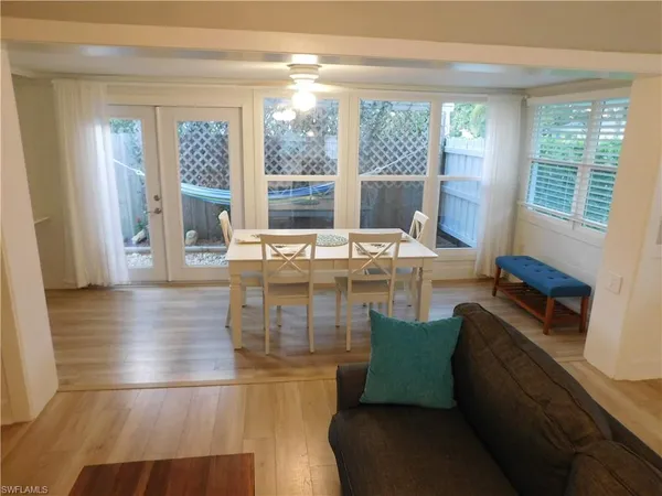 a room with wooden floor and glass door