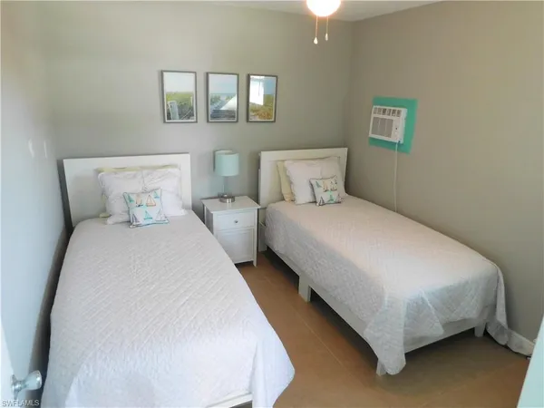 a bedroom with a bed and a night stand