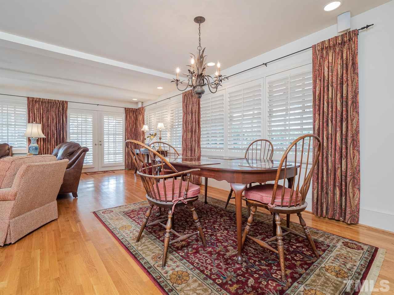 1811 Craig Street Raleigh, NC 27608 - Photo 11 of 28 a dining room with furniture a chandelier and wooden floor