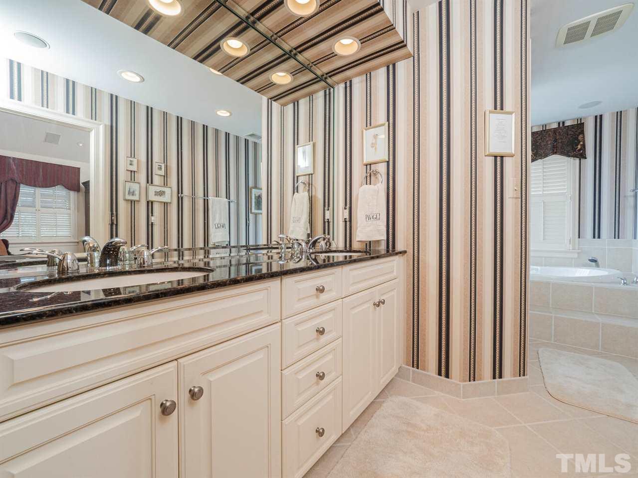 1811 Craig Street Raleigh, NC 27608 - Photo 14 of 28 a bathroom with a double vanity sink and a bathtub