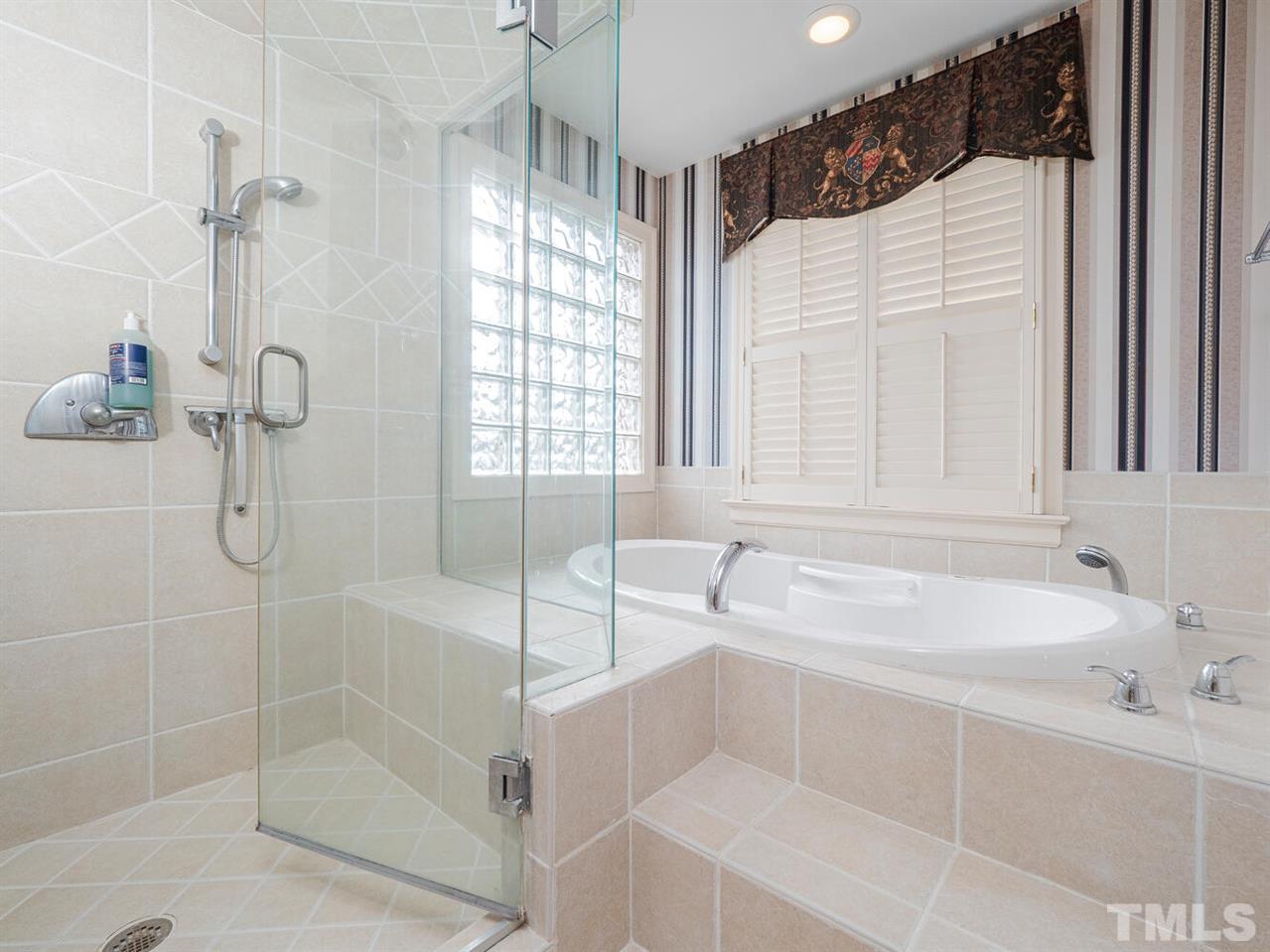 1811 Craig Street Raleigh, NC 27608 - Photo 15 of 28 a bathroom with a tub a sink and glass door shower