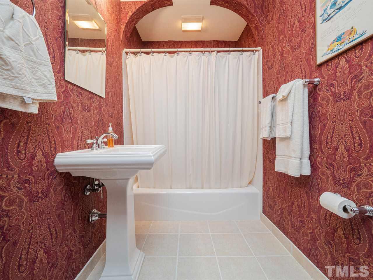 1811 Craig Street Raleigh, NC 27608 - Photo 17 of 28 a bathroom with a sink a mirror and shower