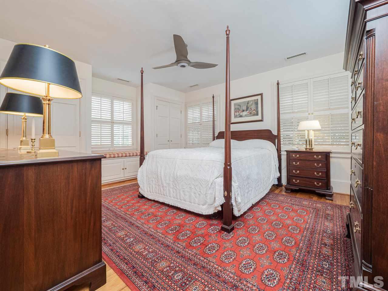 1811 Craig Street Raleigh, NC 27608 - Photo 19 of 28 a bedroom with a large bed and a lamp