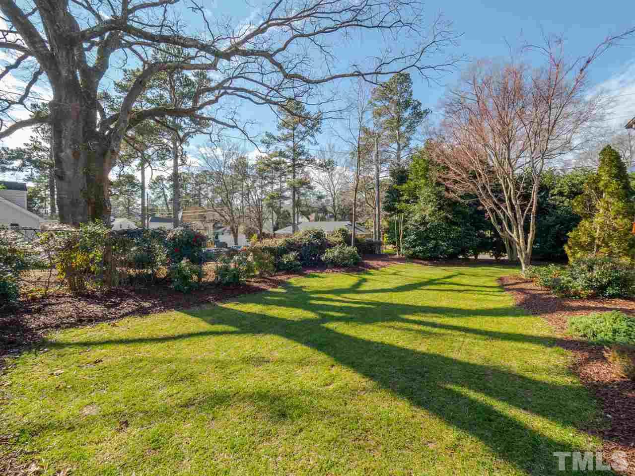 1811 Craig Street Raleigh, NC 27608 - Photo 27 of 28 a view of a swimming pool and trees in the background