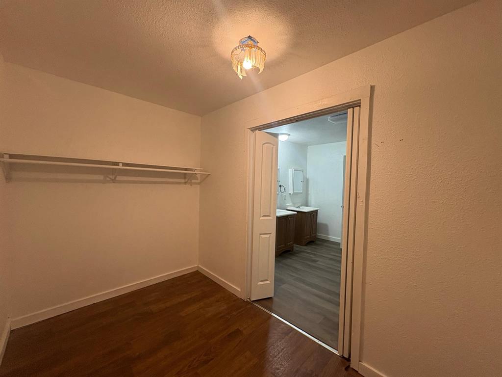 2998 County Road 658 Farmersville, TX 75442 - Photo 12 of 26 a view of a room with wooden floor cabinet and a bathroom