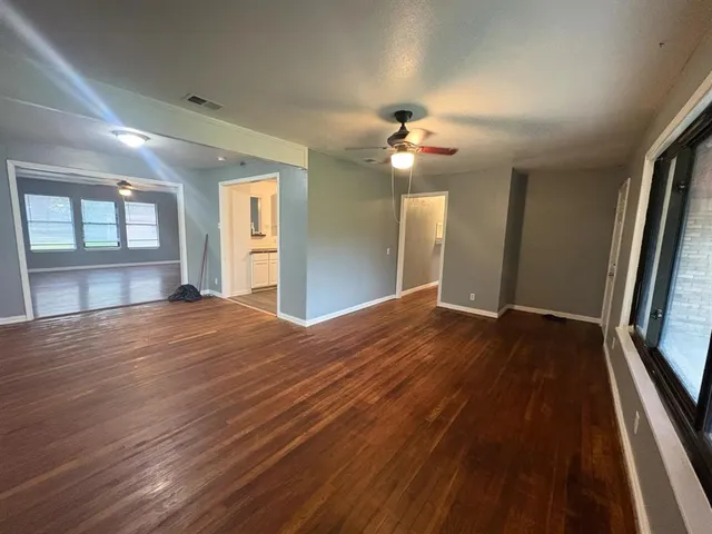 wooden floor in an empty room with a window