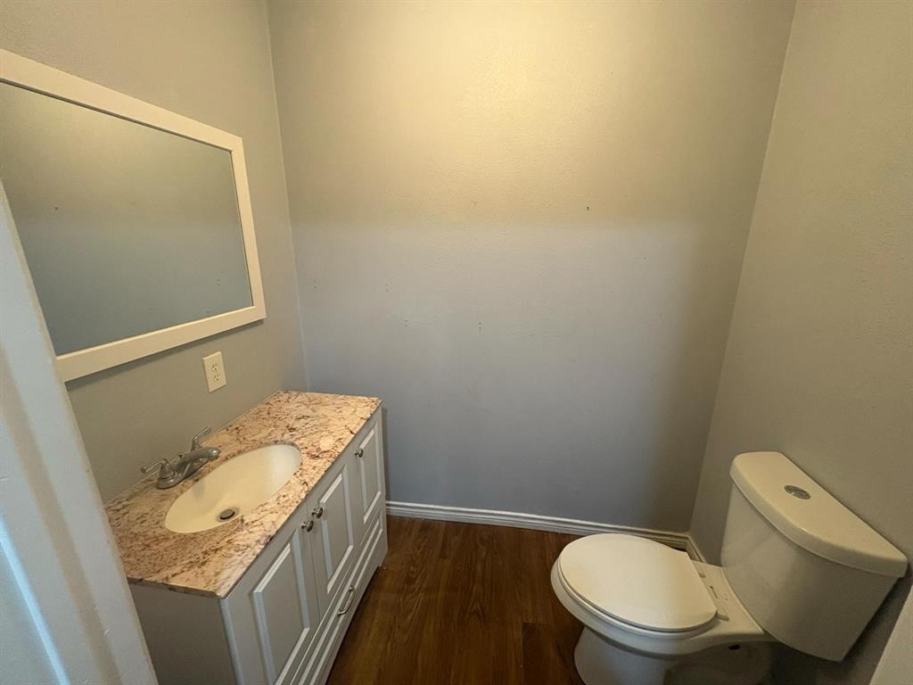 2998 County Road 658 Farmersville, TX 75442 - Photo 20 of 26 a bathroom with a granite countertop toilet and a sink
