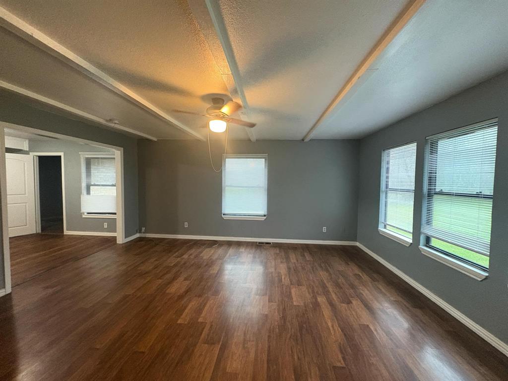 2998 County Road 658 Farmersville, TX 75442 - Photo 21 of 26 a view of an empty room with wooden floor and a window