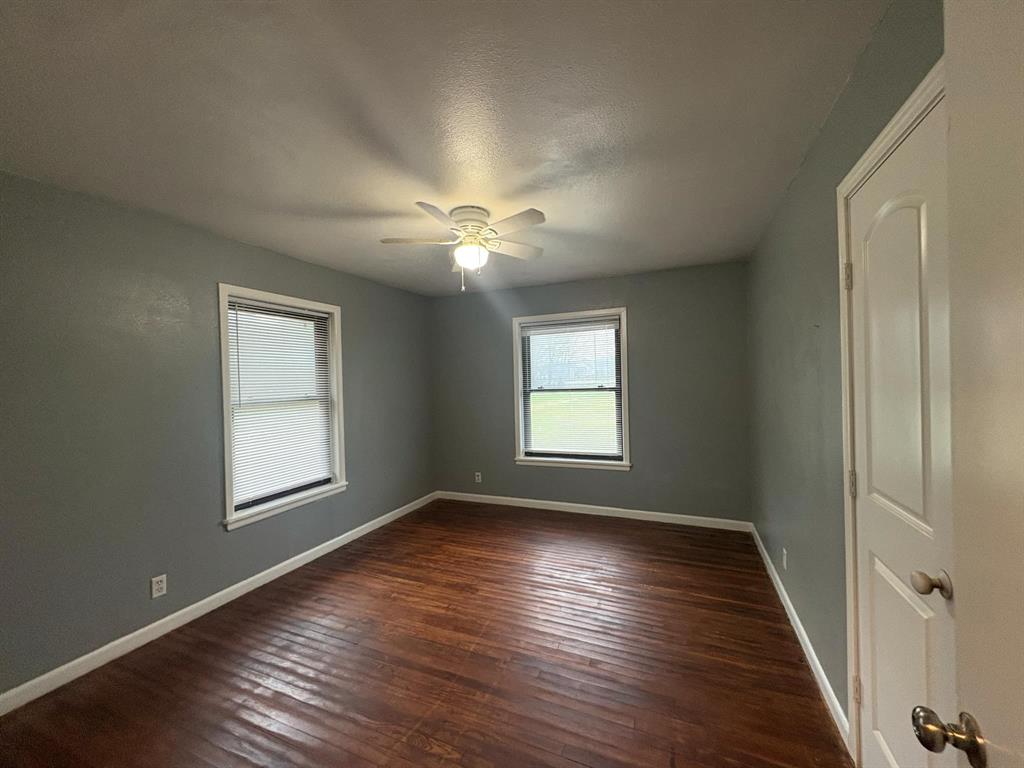 2998 County Road 658 Farmersville, TX 75442 - Photo 25 of 26 a view of an empty room with wooden floor and a window