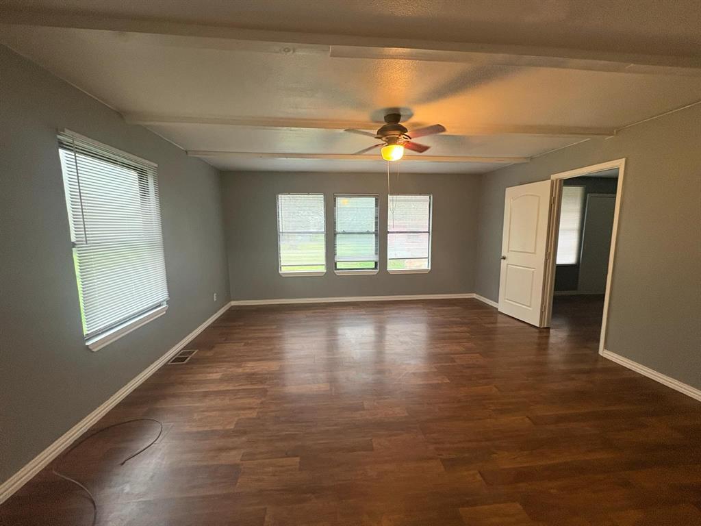 2998 County Road 658 Farmersville, TX 75442 - Photo 6 of 26 a view of an empty room with wooden floor and a window