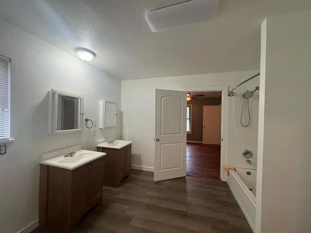 a bathroom with a double vanity sink and mirror