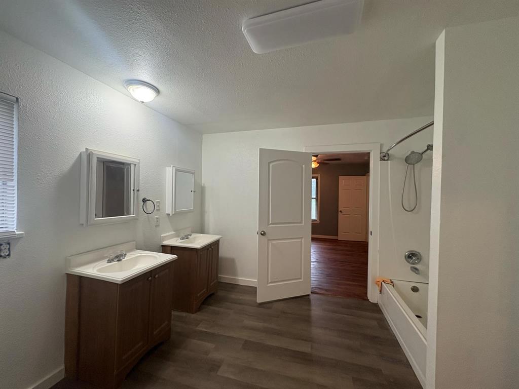 2998 County Road 658 Farmersville, TX 75442 - Photo 8 of 26 a bathroom with a double vanity sink and mirror