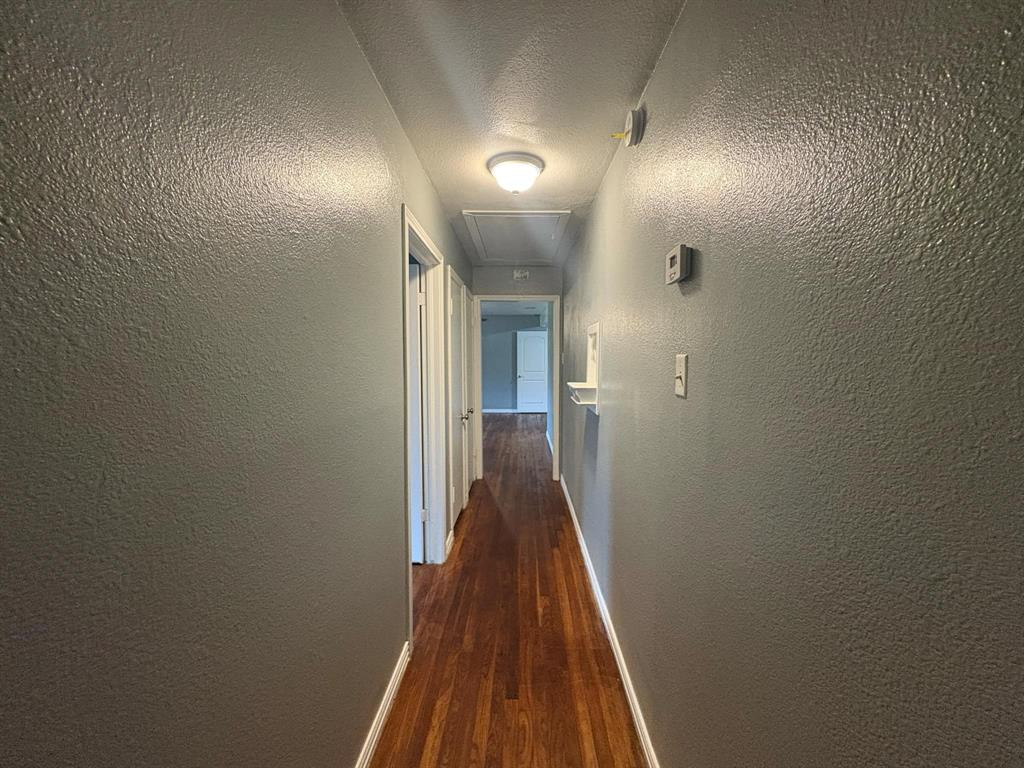 2998 County Road 658 Farmersville, TX 75442 - Photo 9 of 26 a view of a hallway with wooden floor