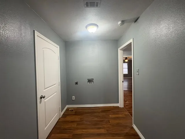 an empty room with wooden floor and closet