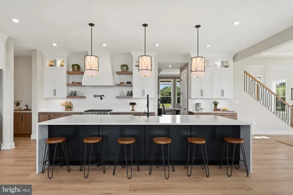 a view of a living room with furniture and floor to ceiling windows