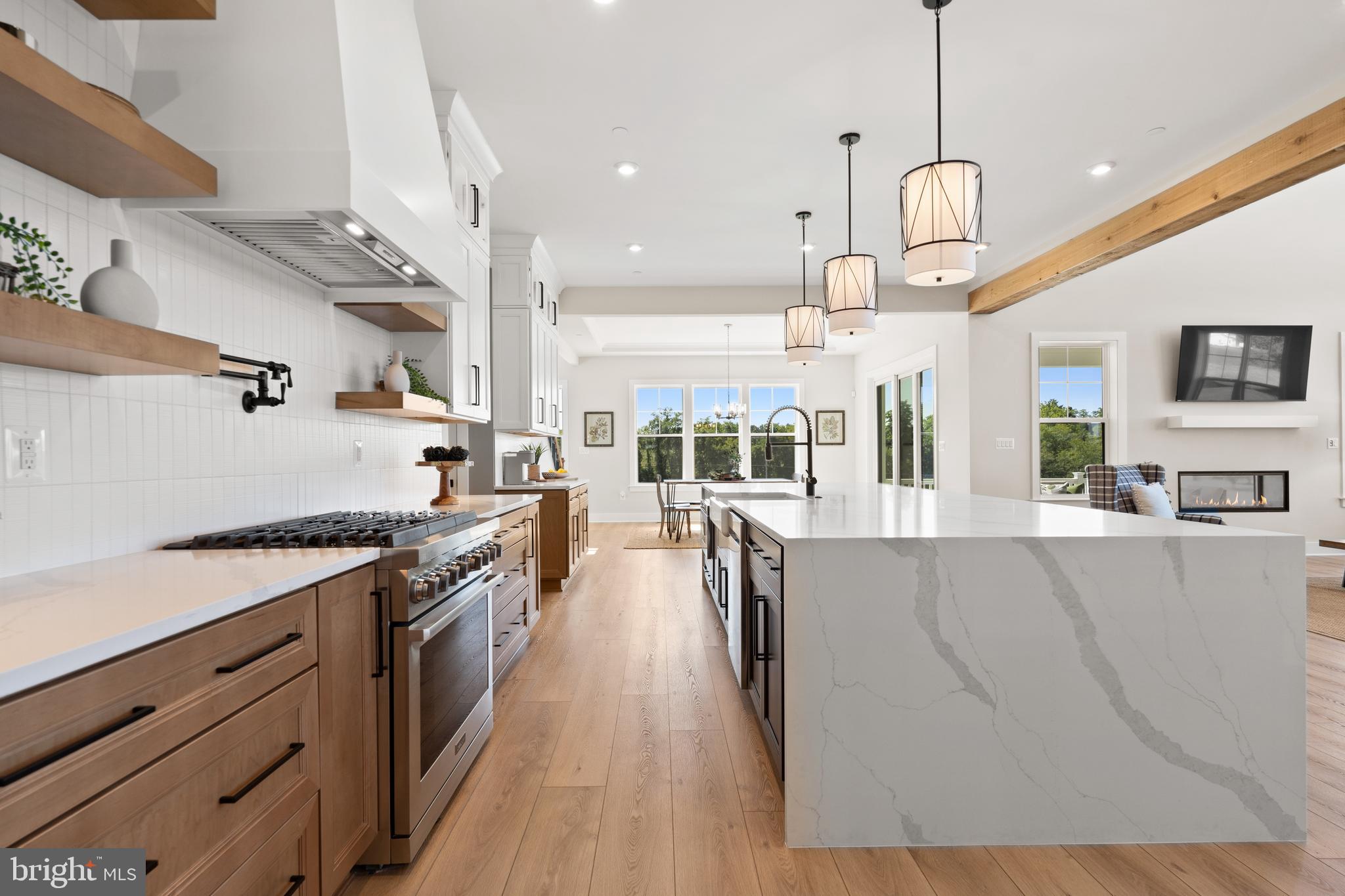 21331 Big Woods Road Dickerson, MD 20842 - Photo 18 of 79 a large kitchen with stainless steel appliances lots of counter space and a chandelier