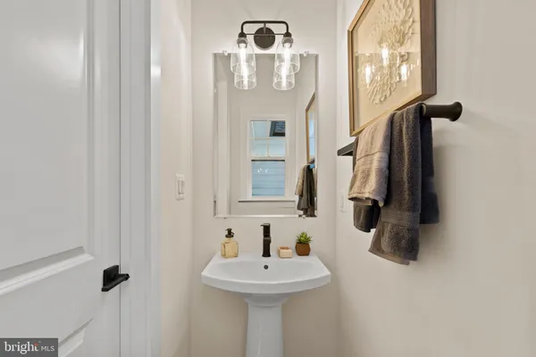 a bathroom with a double vanity sink mirror and bathtub
