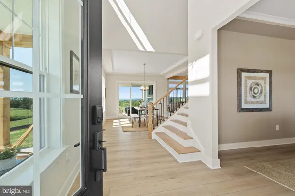 a view of a dining room with furniture and chandelier
